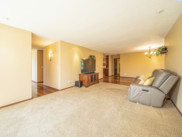9203 Yakima Ct, Yakima, WA 98908 - unfurnished living room featuring carpet flooring, baseboards, and a chandelier