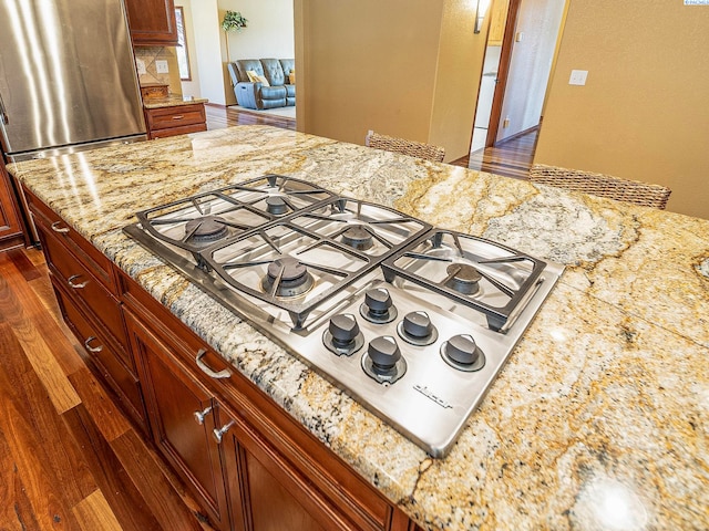 9203 Yakima Ct, Yakima, WA 98908 - kitchen view of appliances with stainless steel finishes, light stone countertops, and dark wood-style floors
