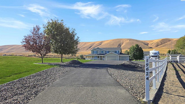 view of street with a mountain view and aphalt driveway