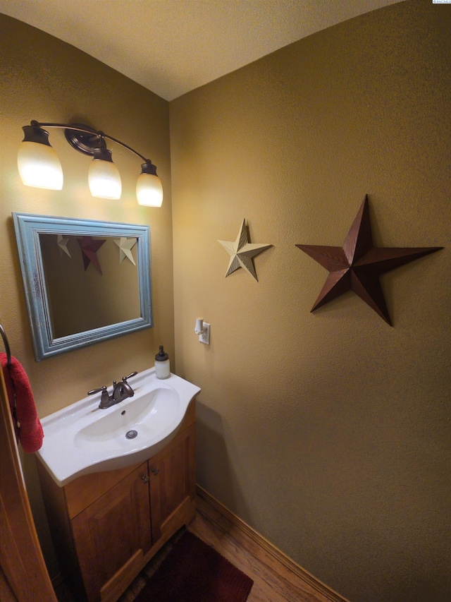 19624 Webber Canyon Rd, Benton City, WA 99320 - bathroom featuring baseboards, wood finished floors, and vanity