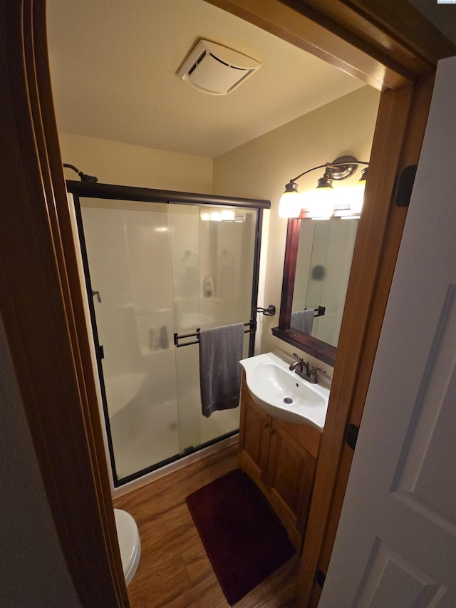 19624 Webber Canyon Rd, Benton City, WA 99320 - full bathroom with vanity, wood finished floors, visible vents, a stall shower, and toilet