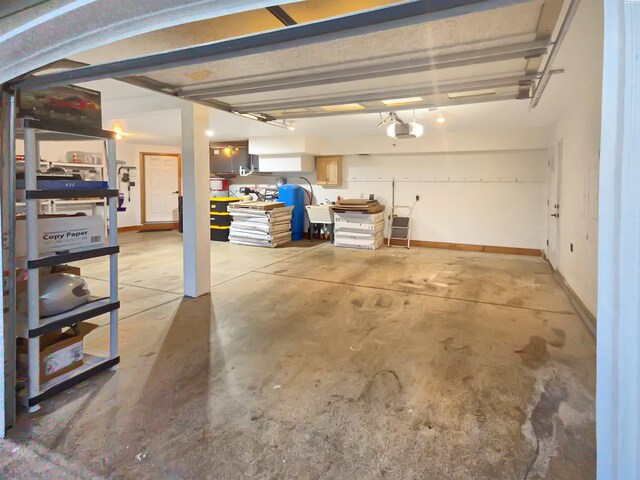 garage with a garage door opener and baseboards