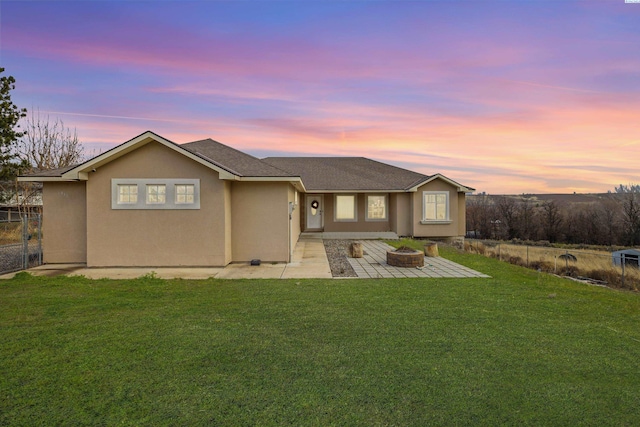 single story home featuring a yard and a patio area