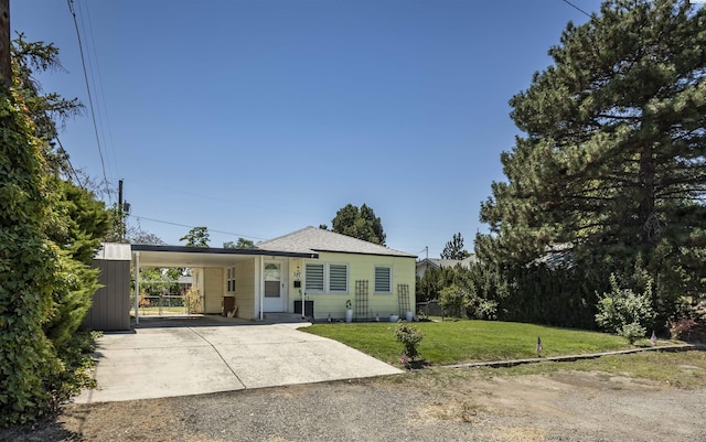 single story home with a front lawn and a carport