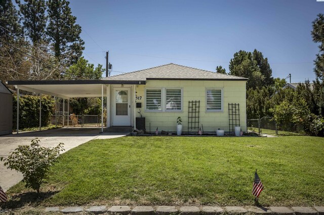 view of front of property featuring a front yard and a carport