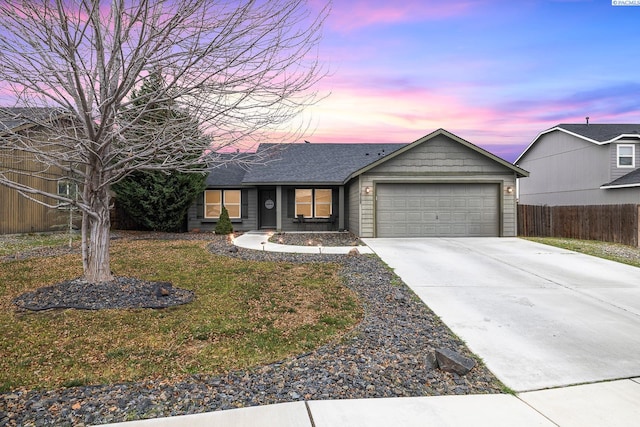 single story home featuring a garage and a yard