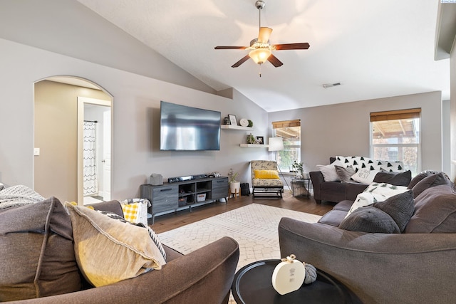 living room featuring vaulted ceiling, dark wood-type flooring, and a wealth of natural light