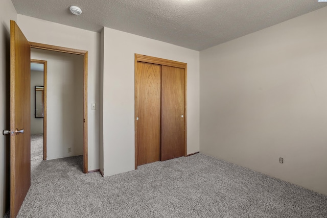 2001 Benson Ave, Prosser, WA 99350 - unfurnished bedroom with carpet floors, a closet, and a textured ceiling