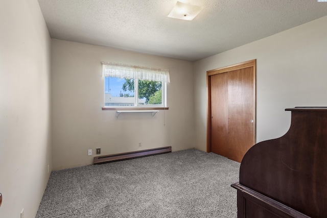 2001 Benson Ave, Prosser, WA 99350 - unfurnished bedroom with a baseboard radiator, carpet floors, a closet, and a textured ceiling