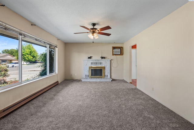 2001 Benson Ave, Prosser, WA 99350 - unfurnished living room featuring a baseboard heating unit, a ceiling fan, carpet flooring, a brick fireplace, and an AC wall unit