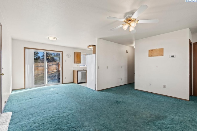 unfurnished living room featuring ceiling fan and dark carpet