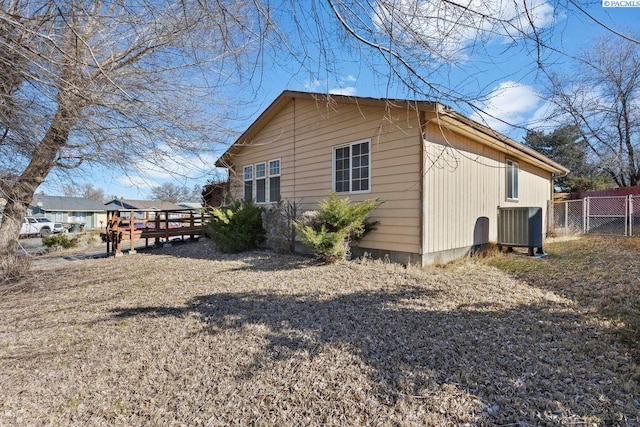 view of property exterior with a wooden deck and cooling unit