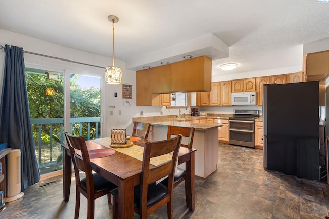 5500 W 26th Ave, Kennewick, WA 99338 - dining room featuring plenty of natural light and stone finish floors
