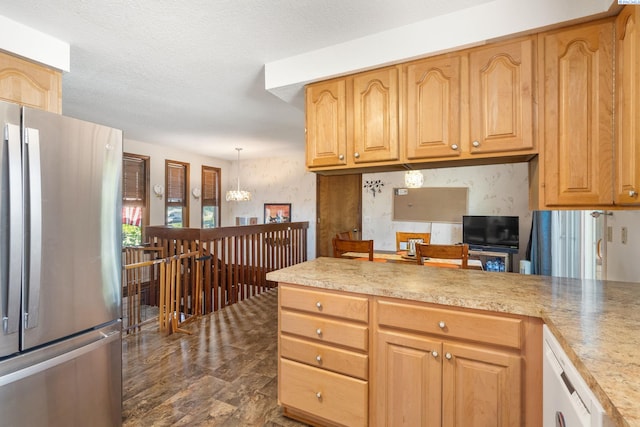 5500 W 26th Ave, Kennewick, WA 99338 - kitchen with freestanding refrigerator, light countertops, a peninsula, pendant lighting, and a chandelier