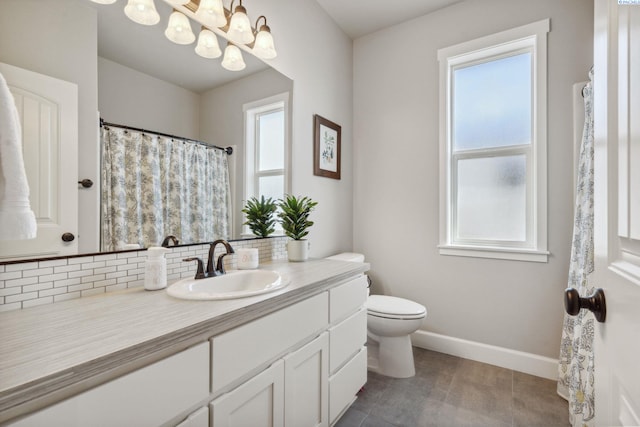 6624 Recurve Rd, Pasco, WA 99301 - full bathroom with healthy amount of natural light, a chandelier, toilet, and backsplash