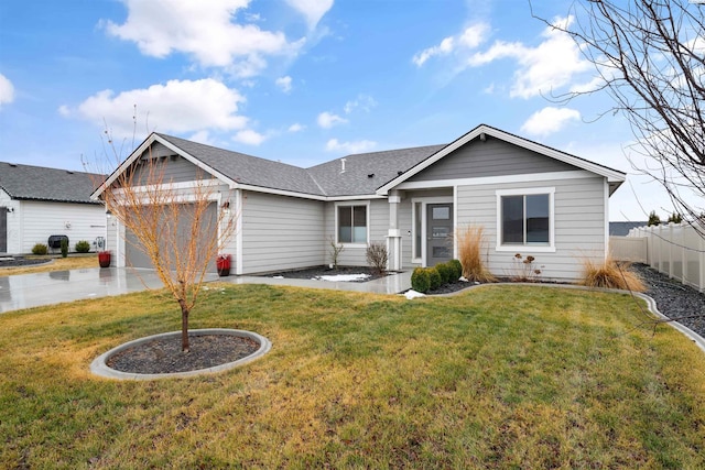 ranch-style home featuring a garage, driveway, a shingled roof, fence, and a front yard