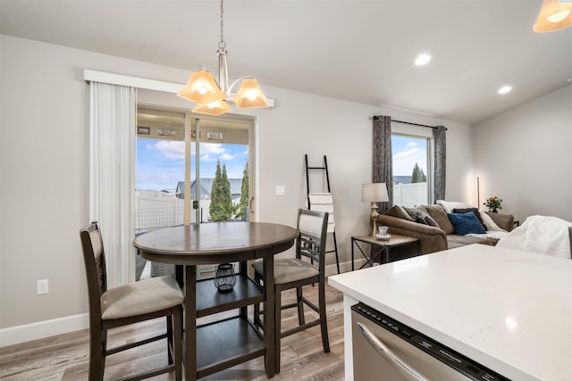 dining space with a view of city, wood finished floors, and a wealth of natural light