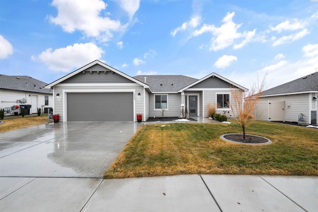 single story home with a garage, driveway, a shingled roof, and a front yard