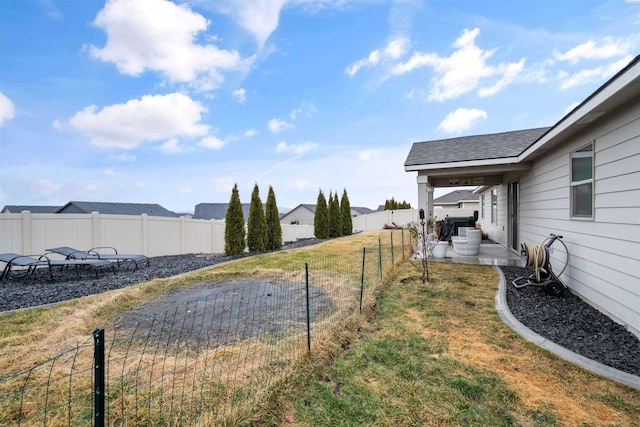 view of yard featuring a patio and a fenced backyard