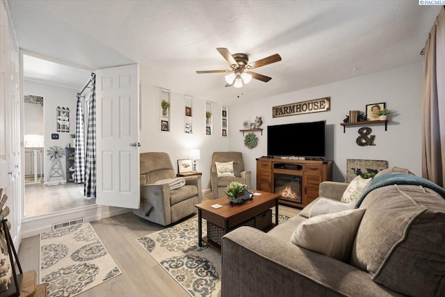 736 E 5th Ave, Kennewick, WA 99336 - living area featuring ceiling fan, light wood-style floors, and a glass covered fireplace