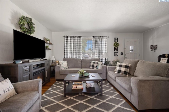 736 E 5th Ave, Kennewick, WA 99336 - living room featuring wood finished floors and a lit fireplace