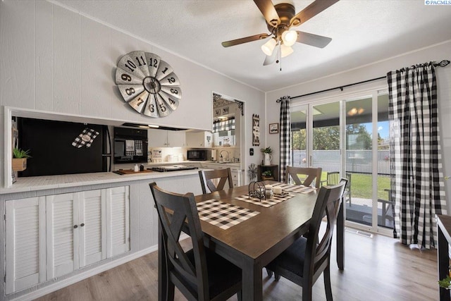 736 E 5th Ave, Kennewick, WA 99336 - dining area featuring light wood-type flooring, ceiling fan, ornamental molding, and a textured ceiling
