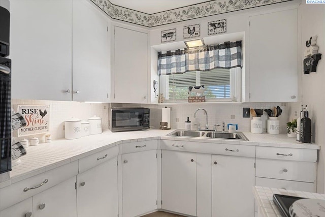 736 E 5th Ave, Kennewick, WA 99336 - kitchen featuring black microwave, white cabinets, decorative backsplash, and light countertops