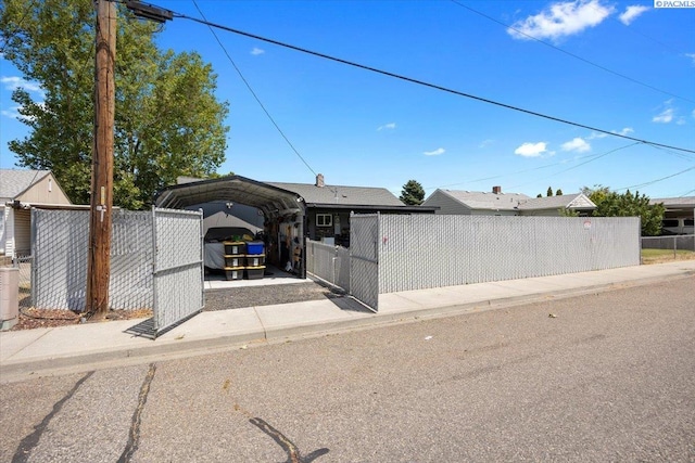 736 E 5th Ave, Kennewick, WA 99336 - view of front of home with a detached carport and a fenced front yard