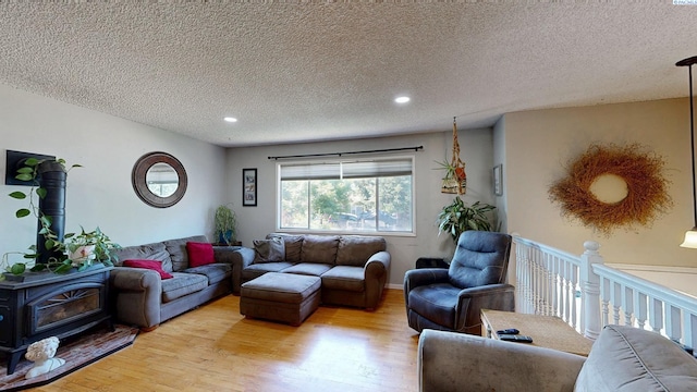 220 E Cannon, Palouse, WA 99161 - living room featuring light wood-type flooring, a wood stove, a textured ceiling, and recessed lighting