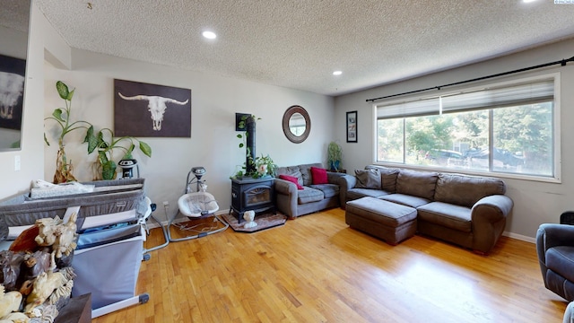 220 E Cannon, Palouse, WA 99161 - living area featuring a textured ceiling, wood finished floors, recessed lighting, and a wood stove