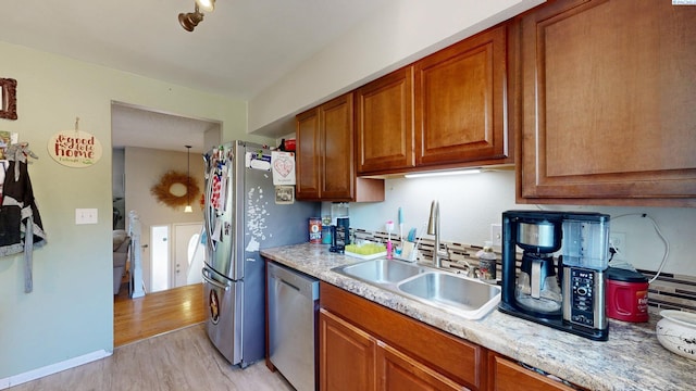 220 E Cannon, Palouse, WA 99161 - kitchen featuring appliances with stainless steel finishes, light countertops, brown cabinets, and light wood finished floors
