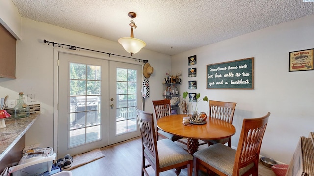 220 E Cannon, Palouse, WA 99161 - dining area featuring french doors, light wood-style flooring, and a textured ceiling
