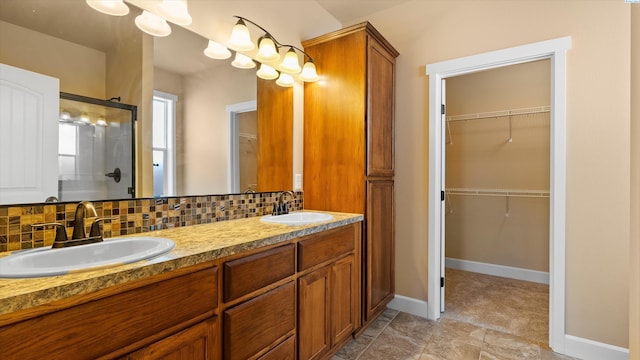 1867 S Fescue St, Kennewick, WA 99338 - bathroom with a shower stall, double vanity, backsplash, and a walk in closet