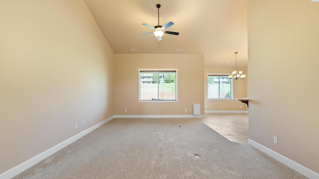 1867 S Fescue St, Kennewick, WA 99338 - spare room with light carpet, a chandelier, a ceiling fan, and lofted ceiling