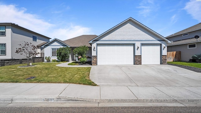 1867 S Fescue St, Kennewick, WA 99338 - view of front of house with a front lawn, stone siding, driveway, and a garage