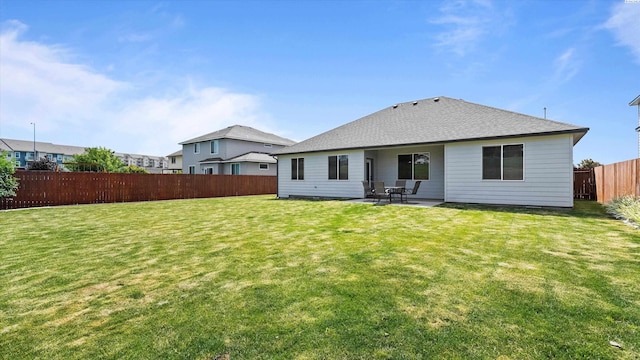 1867 S Fescue St, Kennewick, WA 99338 - rear view of house with a fenced backyard, a patio, and roof with shingles
