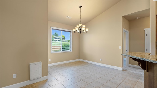 1867 S Fescue St, Kennewick, WA 99338 - unfurnished dining area with vaulted ceiling, light tile patterned floors, and a chandelier
