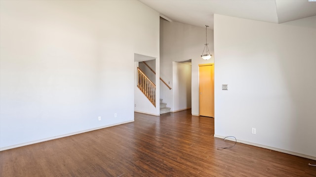 5704 Taft Dr, Pasco, WA 99301 - spare room with wood finished floors, stairs, and high vaulted ceiling
