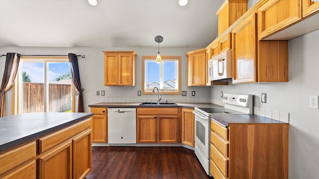 5704 Taft Dr, Pasco, WA 99301 - kitchen with white appliances, plenty of natural light, dark countertops, and dark wood finished floors