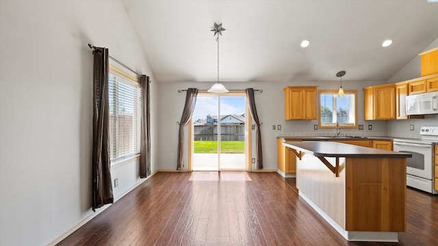 5704 Taft Dr, Pasco, WA 99301 - kitchen featuring white appliances, vaulted ceiling, plenty of natural light, dark wood-type flooring, and recessed lighting