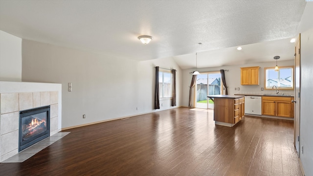 5704 Taft Dr, Pasco, WA 99301 - kitchen with white dishwasher, open floor plan, dark wood-type flooring, healthy amount of natural light, and a textured ceiling