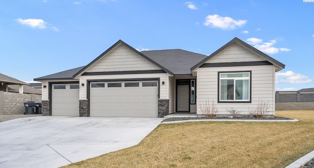 view of front of house featuring driveway, a front lawn, fence, roof with shingles, and an attached garage