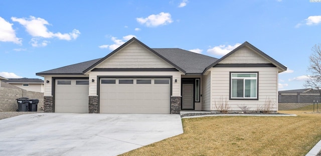 view of front facade with a garage, concrete driveway, a front lawn, and fence