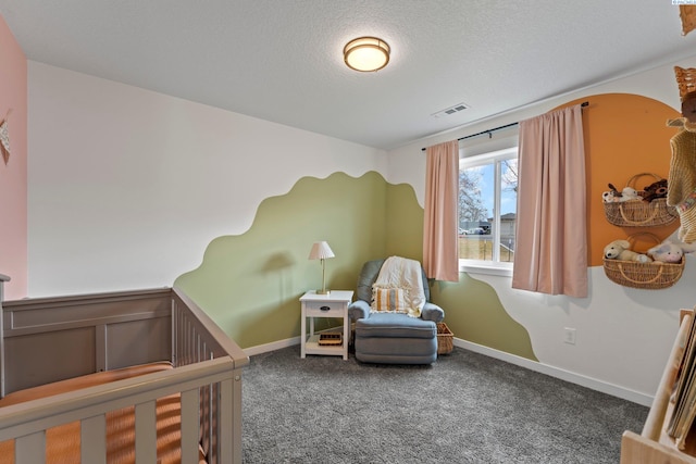 carpeted bedroom with a nursery area, baseboards, visible vents, and a textured ceiling