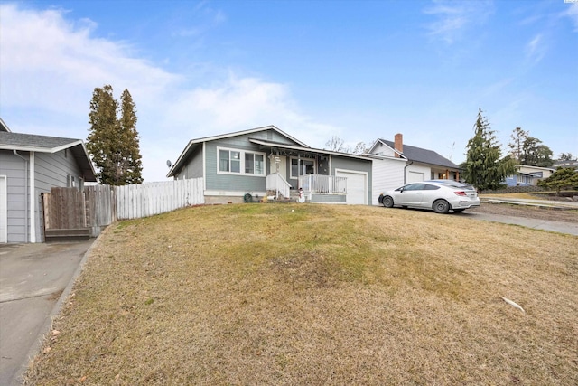 view of front of property with a garage, a front yard, and fence