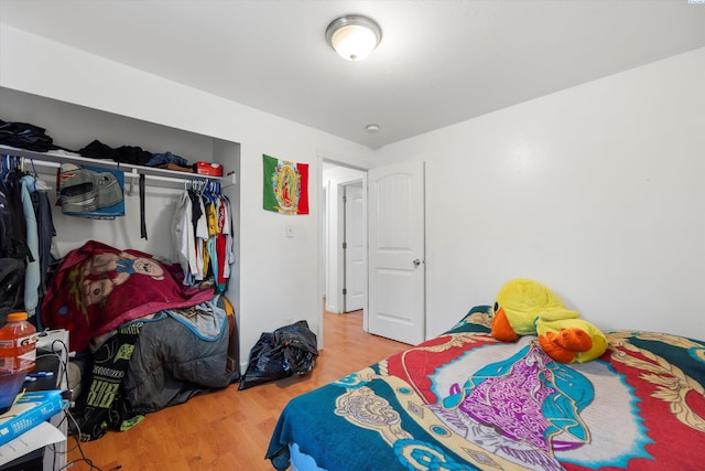 bedroom featuring a closet and light wood-style flooring