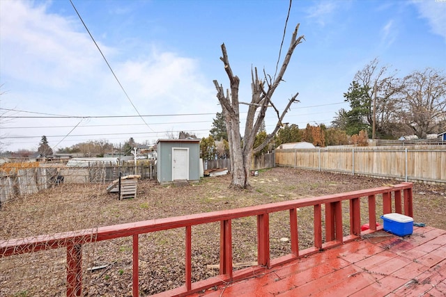 view of patio with an outbuilding, a fenced backyard, a deck, and a storage shed