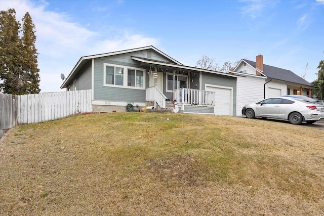 ranch-style home with a garage, fence, a front lawn, and a porch