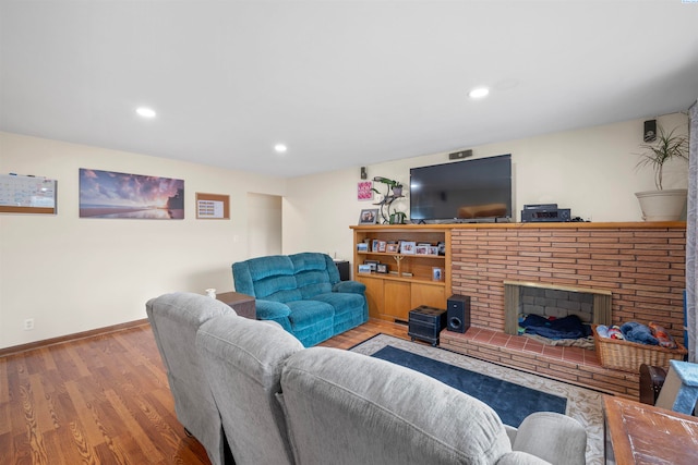 living room with a fireplace and hardwood / wood-style floors