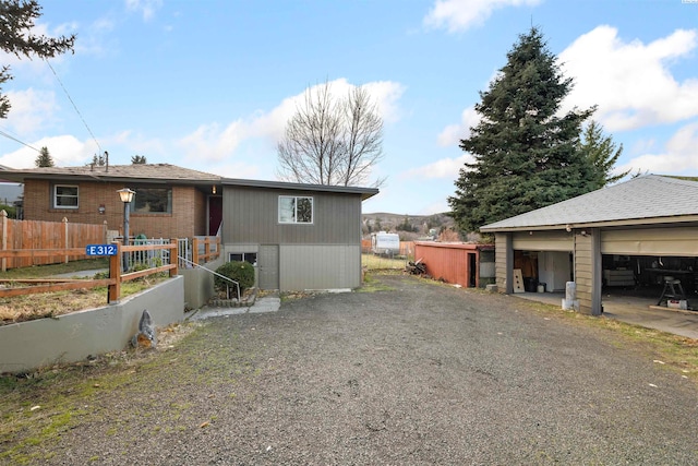 view of home's exterior featuring an outbuilding and a garage